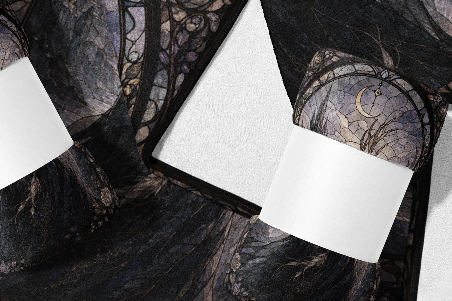 Dark fabric with gothic moon and floral pattern, shown folded with white rectangles.