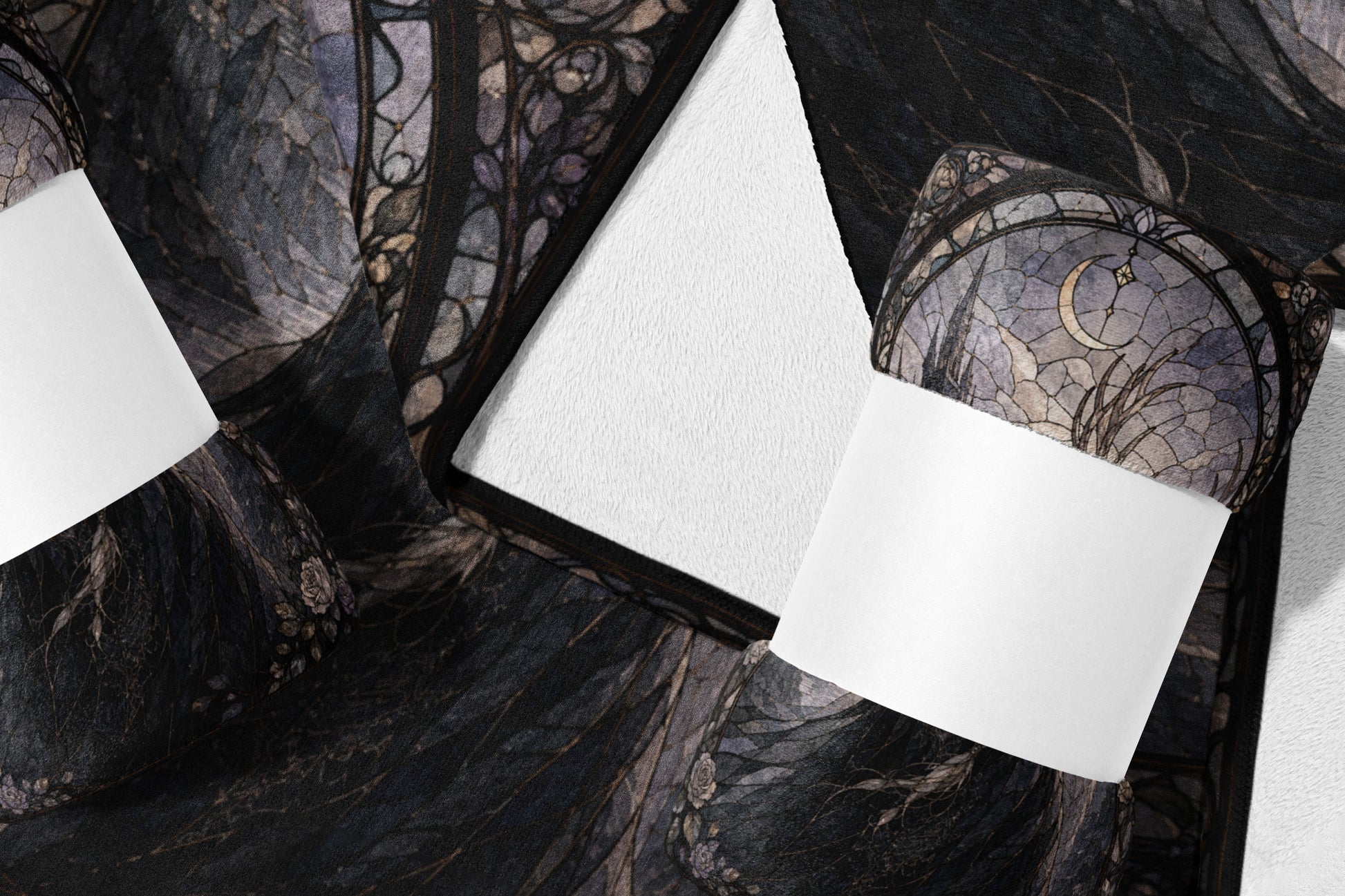 Dark fabric with gothic moon and floral pattern, shown folded with white rectangles.