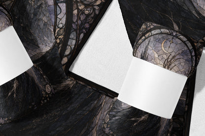Dark fabric with gothic moon and floral pattern, shown folded with white rectangles.