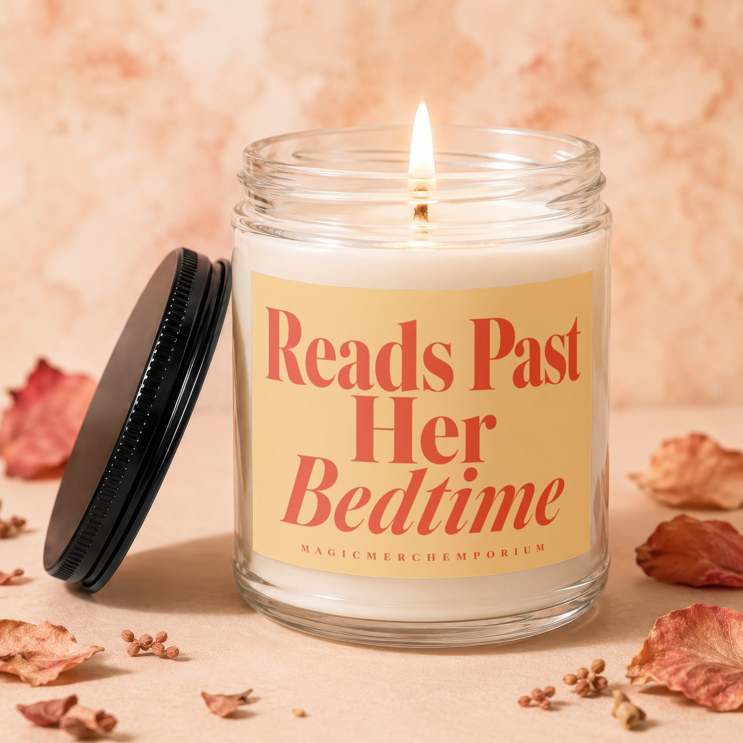 Candle with text "Reads Past Her Bedtime" and "MAGICMERCH" in a glass jar with a lid.