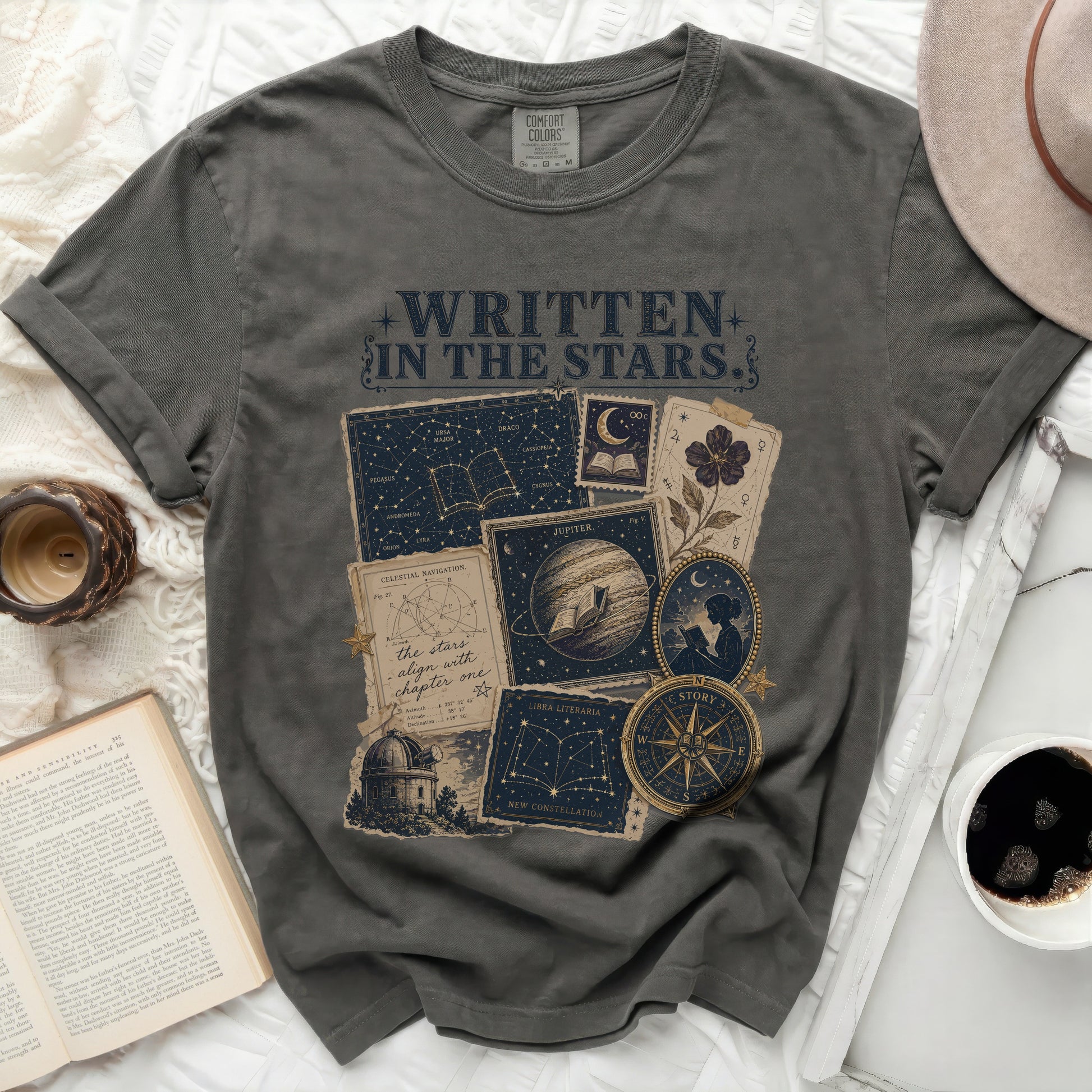T-shirt with "Written in the Stars" text, constellations, and celestial navigation graphics.