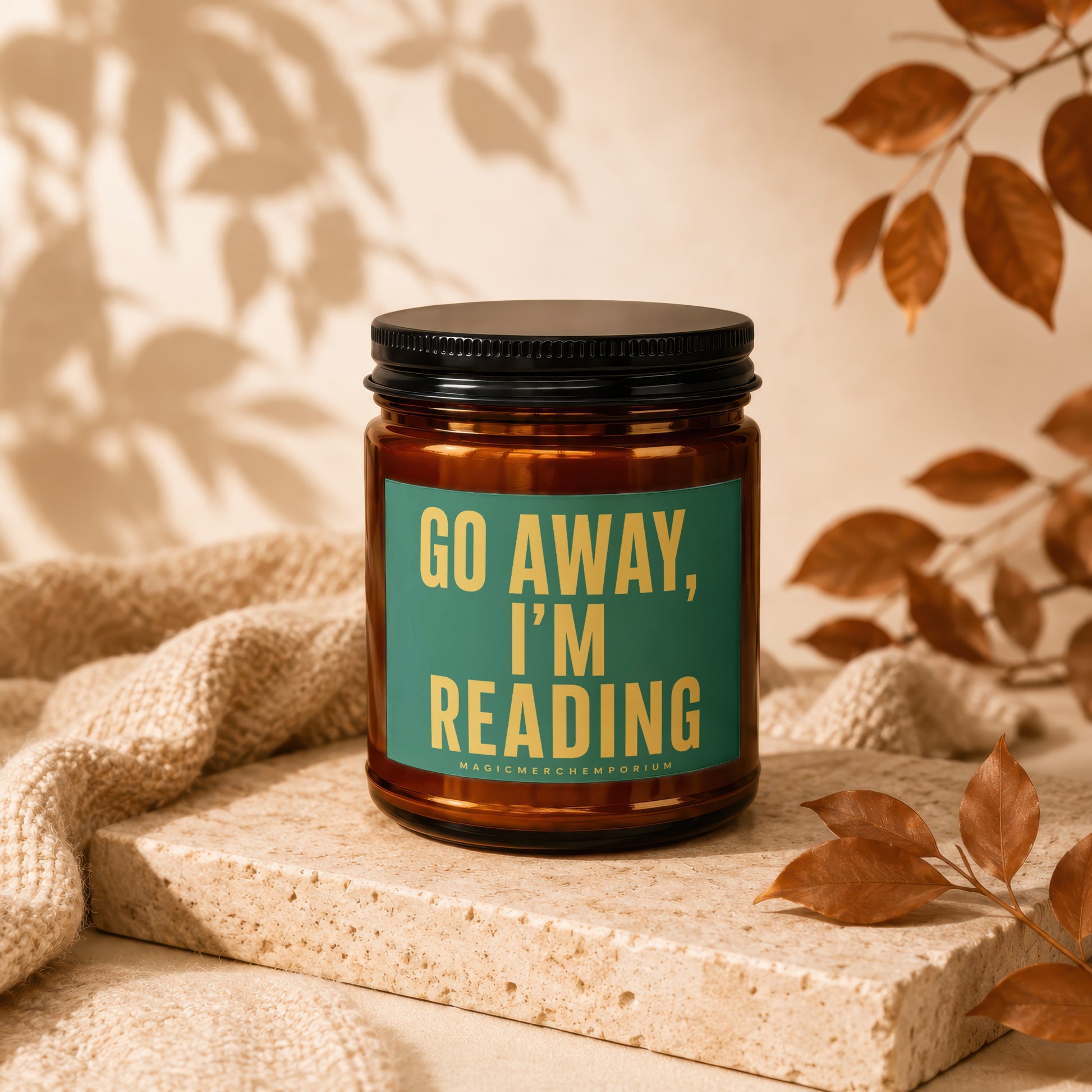 Amber jar candle with "GO AWAY, I'M READING" text on a teal label.