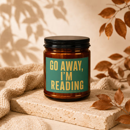 Amber jar candle with "GO AWAY, I'M READING" text on a teal label.