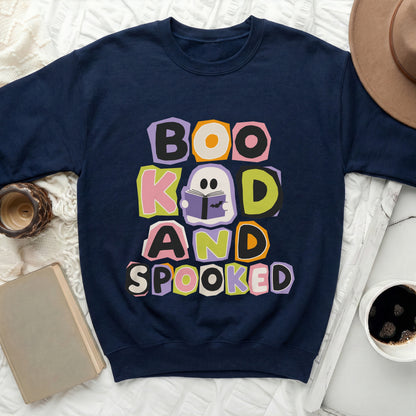 Navy sweatshirt with colorful "Boo Kad and Spooked" ghost reading book graphic.