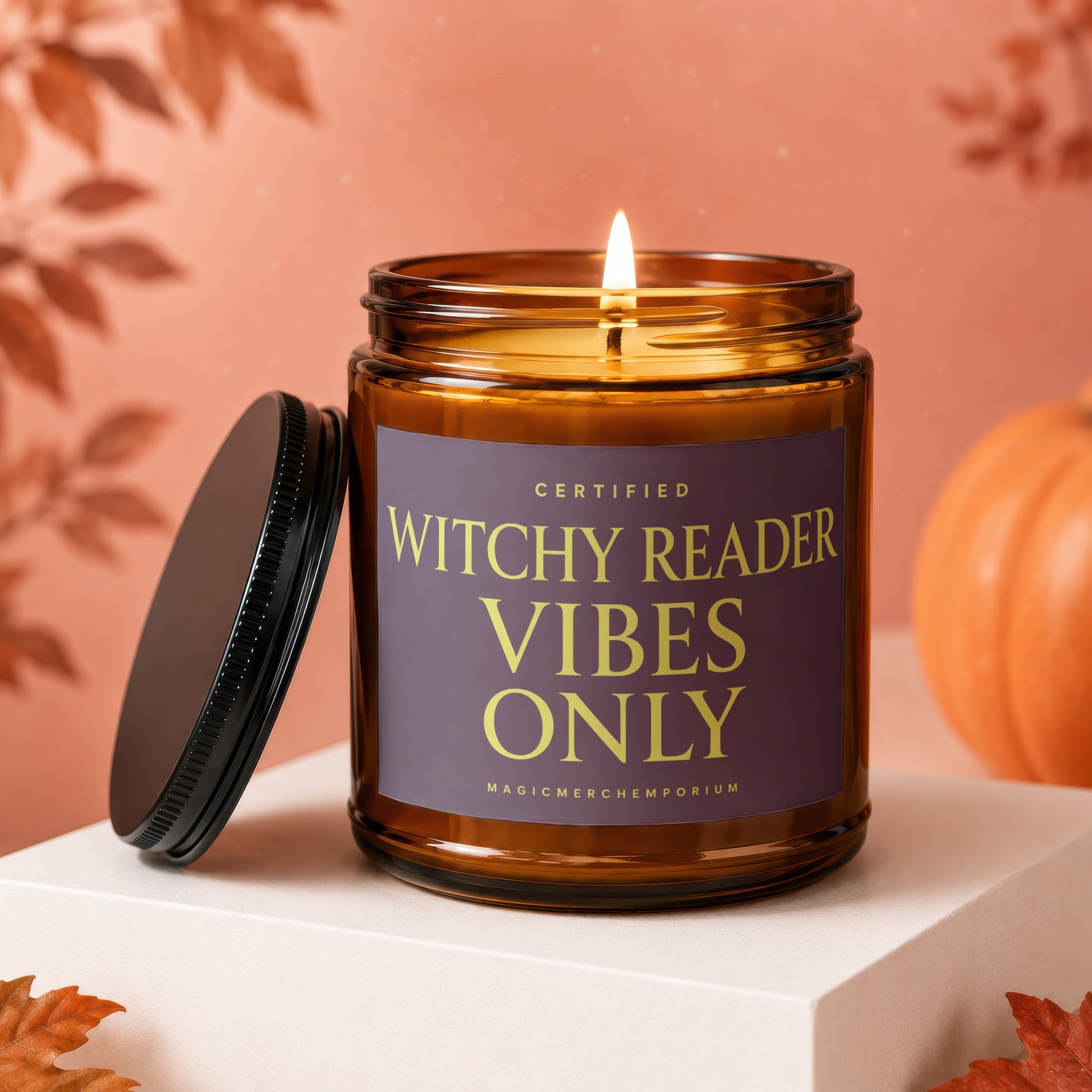 Lit amber candle with "Witchy Reader Vibes Only" on label.