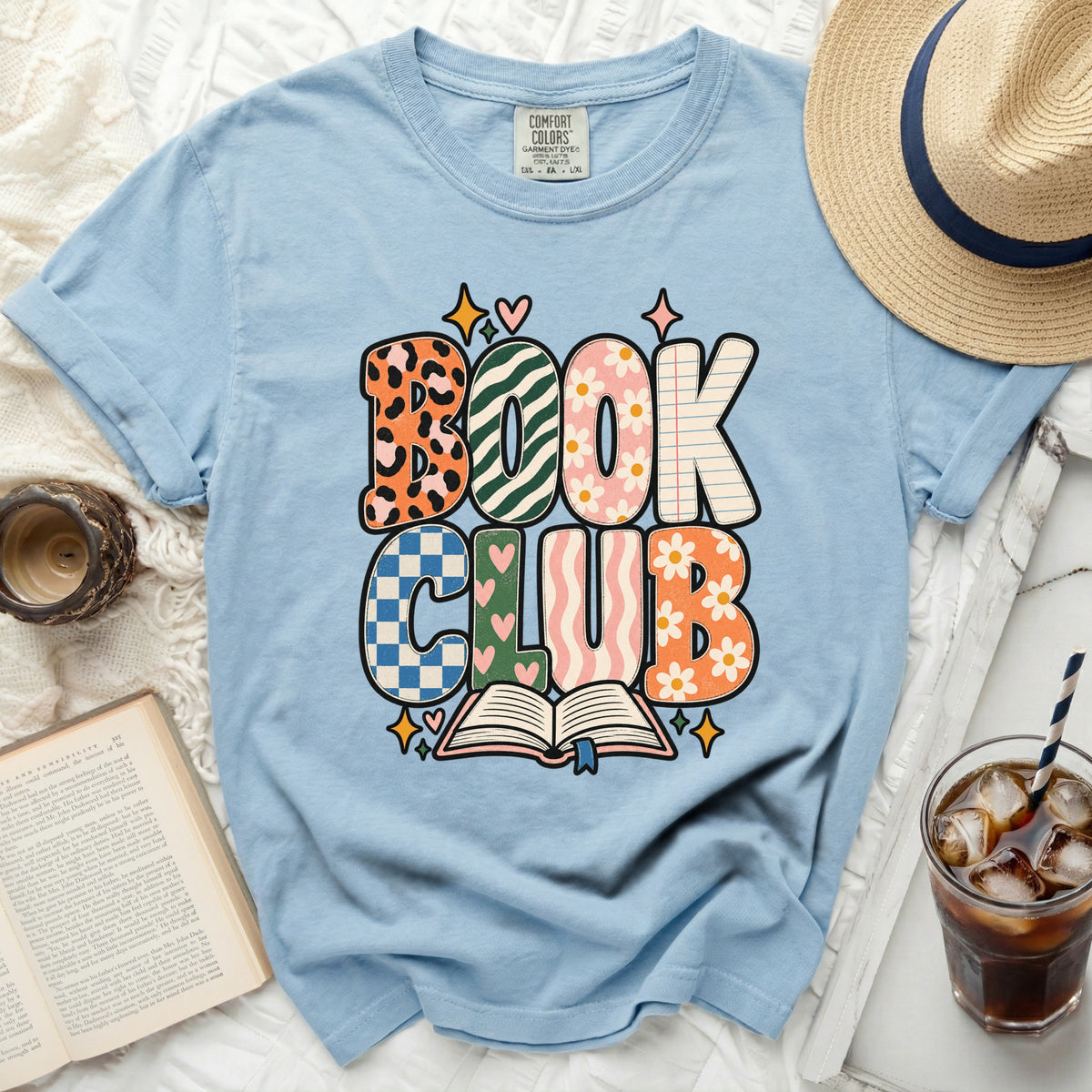 Light blue t-shirt with "BOOK CLUB" graphic featuring an open book and stars.