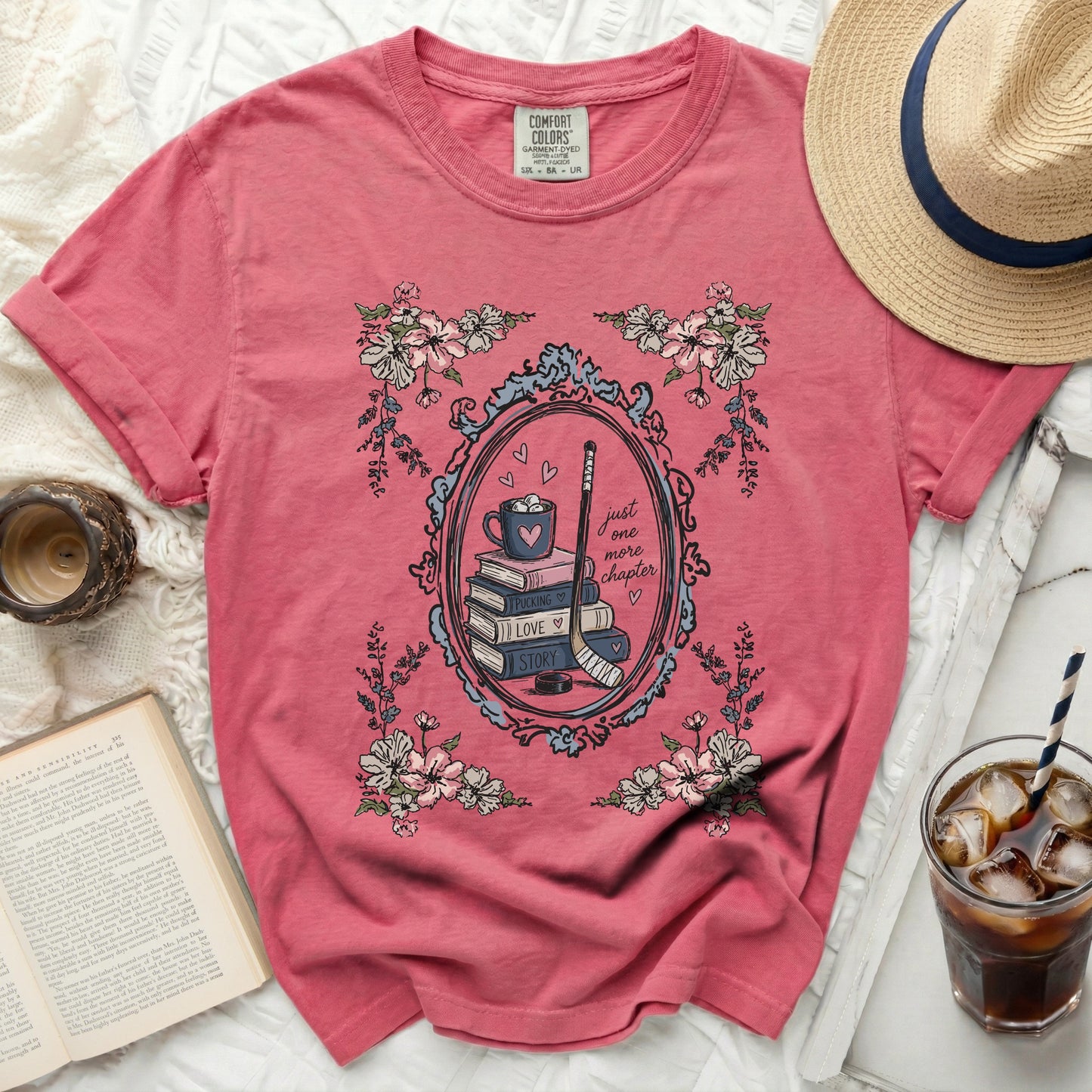 Pink t-shirt with "Just One More Puck Love Story" hockey and book graphic.
