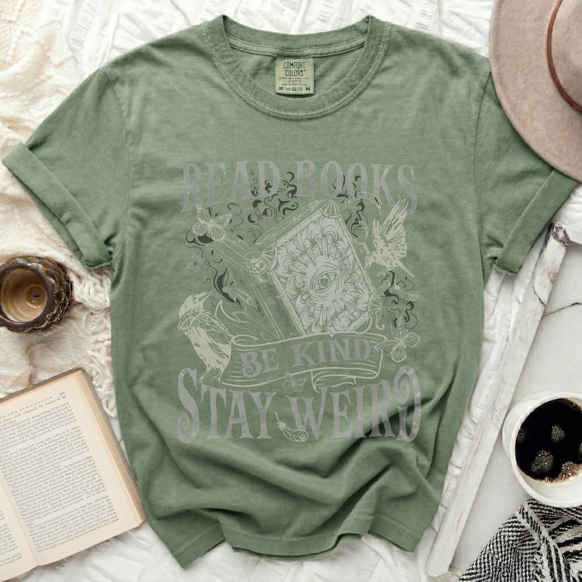 Green t-shirt with "Read Books, Be Kind, Stay Weird" text and graphic.