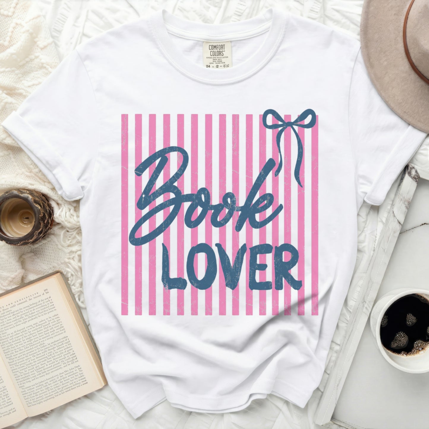 White t-shirt with pink and blue stripes, "Book Lover" text, and bow graphic.