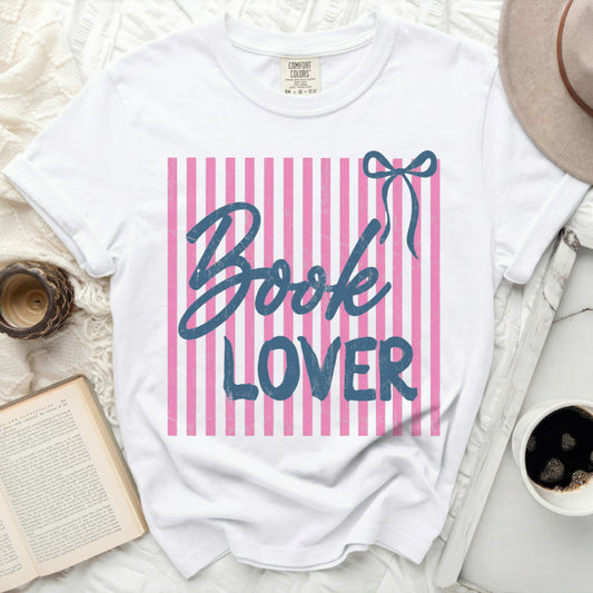 White t-shirt with pink and blue stripes, "Book Lover" text, and bow graphic.