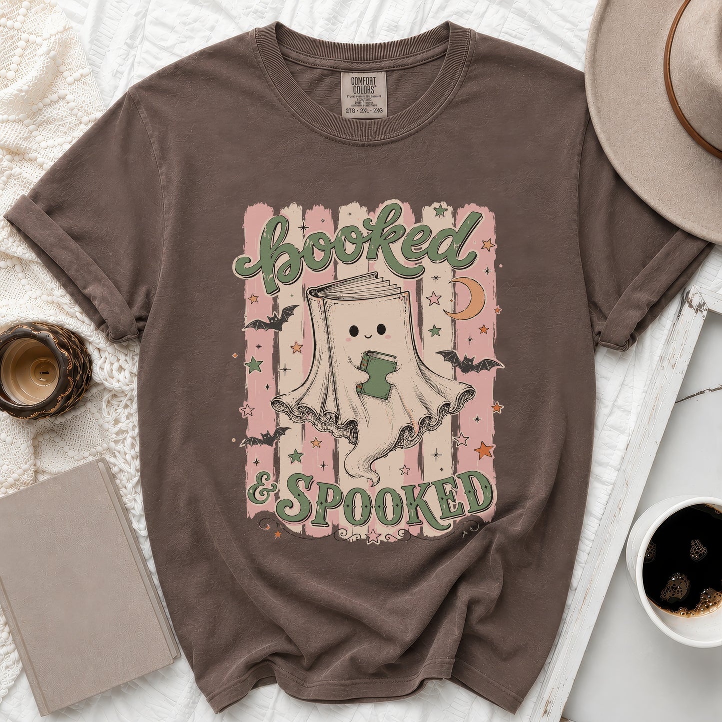Brown t-shirt with "Booked & Spooked" text and a book-ghost illustration.