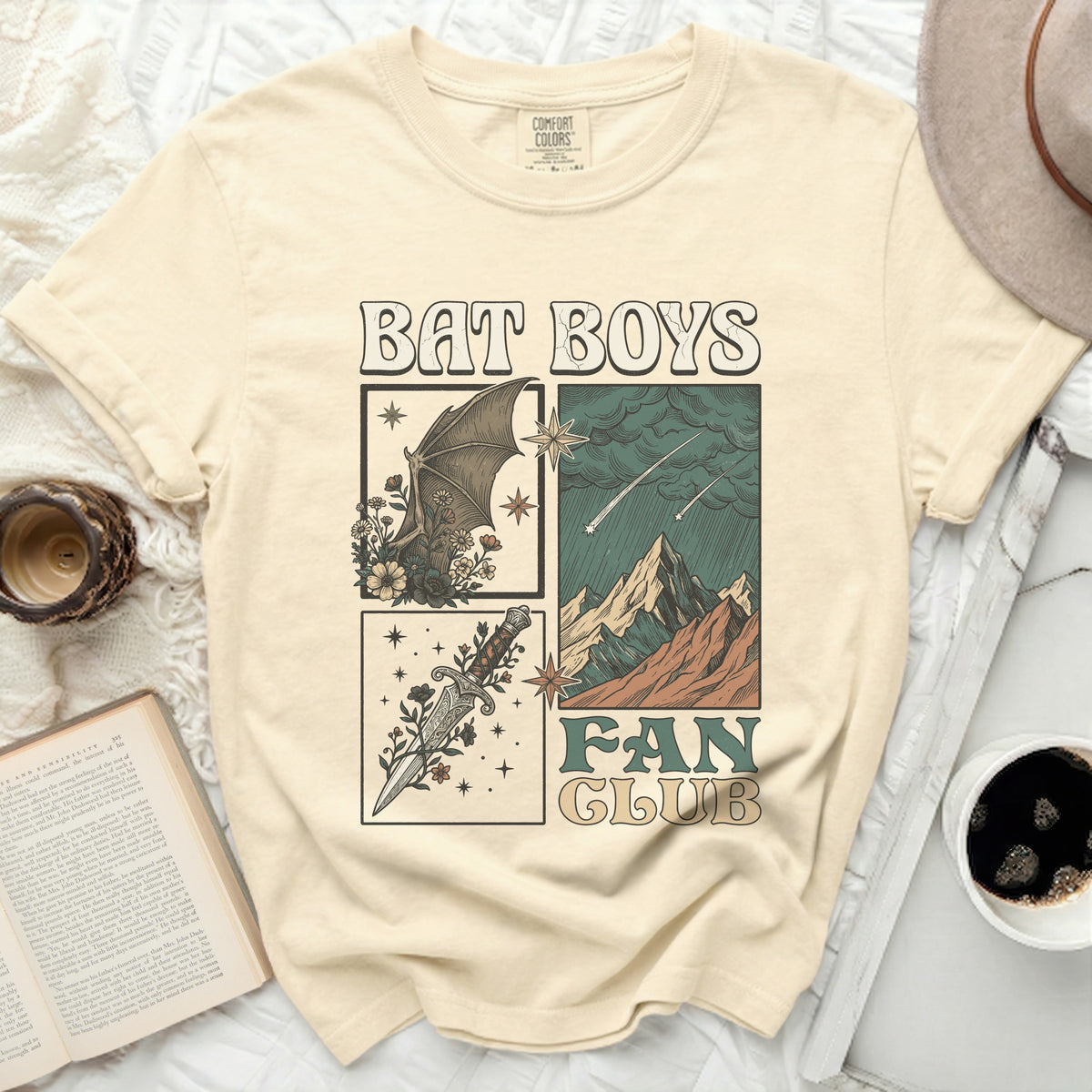 Cream t-shirt with "BAT BOYS FAN CLUB" graphic and stylized illustrations.
