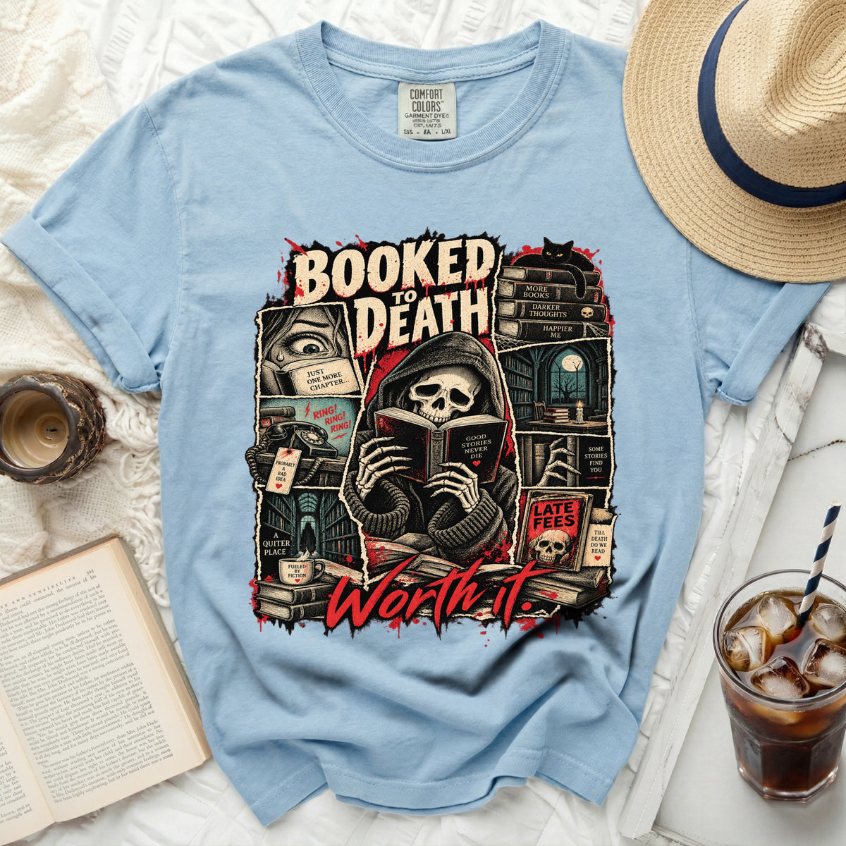 Light blue t-shirt with "Booked to Death Worth It" graphic of a skeleton reading.