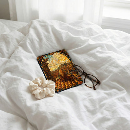 Coaster with stained glass art of city, eagle, and woman on white sheets with glasses.