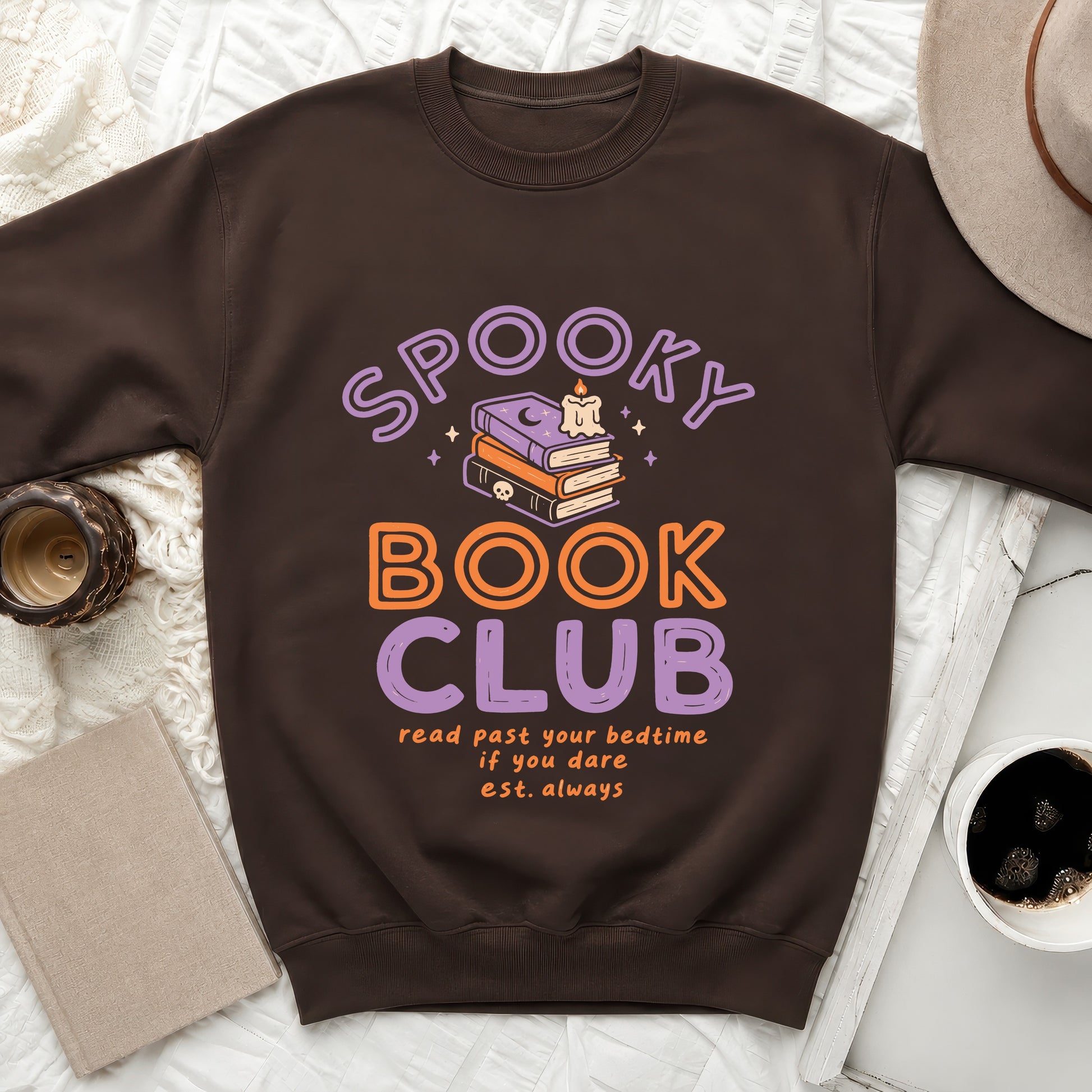 Brown sweatshirt with "Spooky Book Club" graphic and text.