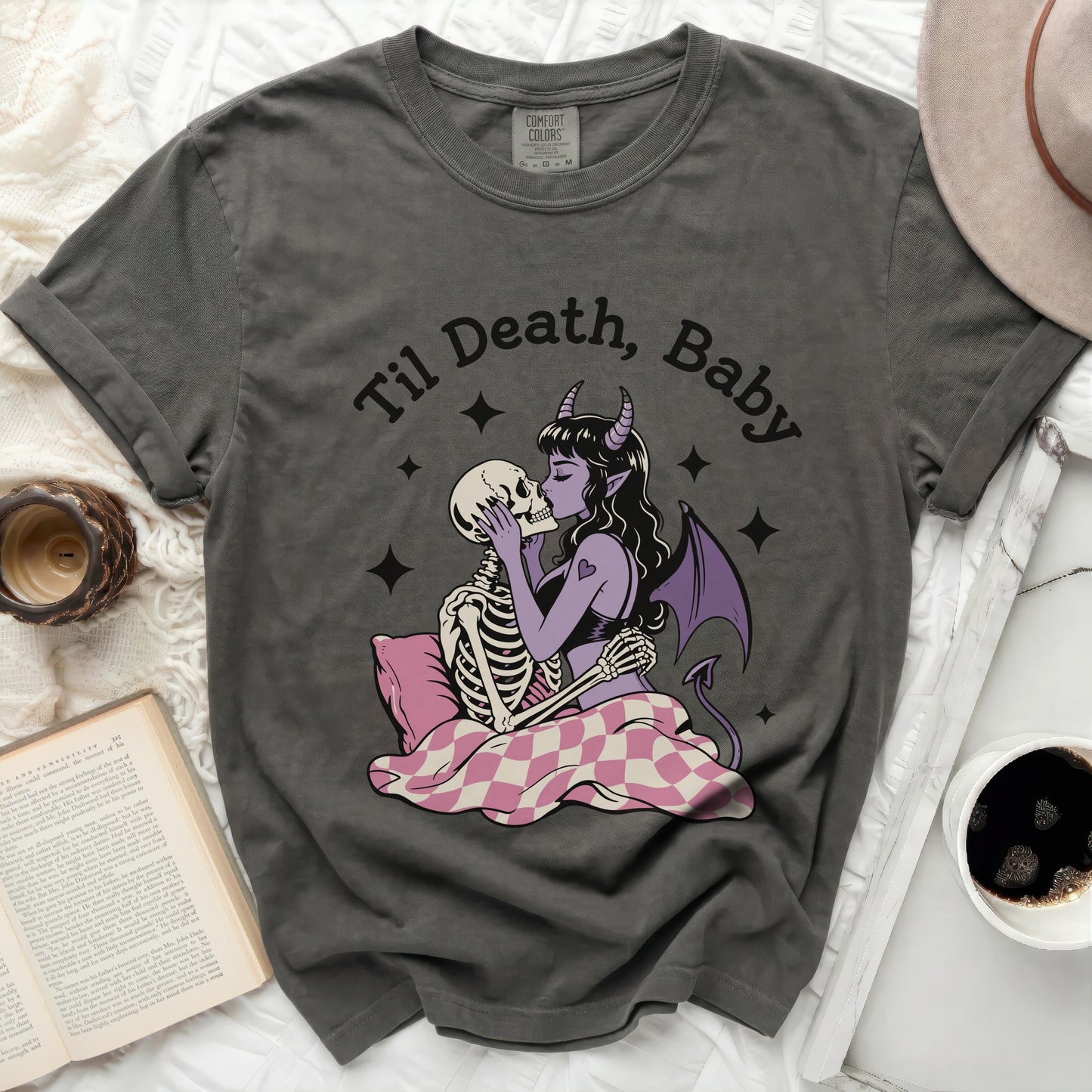 T-shirt with "Til Death, Baby" graphic of skeletons kissing and a devil.