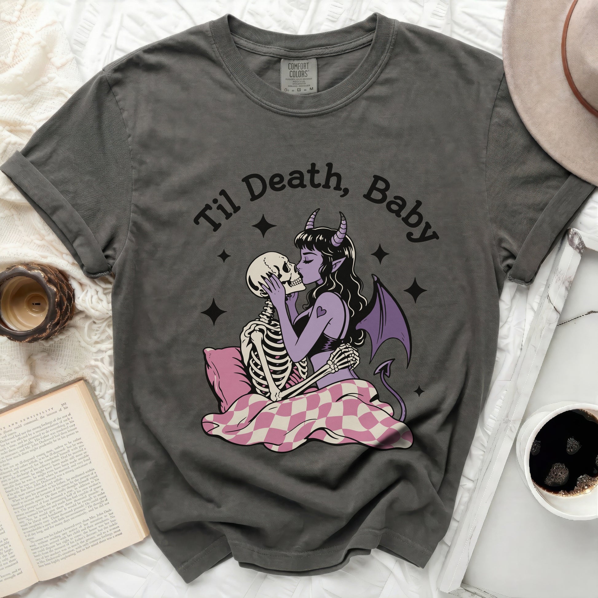 T-shirt with "Til Death, Baby" graphic of skeletons kissing and a devil.