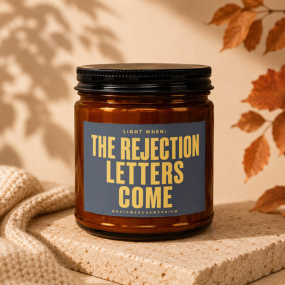 Amber jar candle with text "Light When: The Rejection Letters Come".