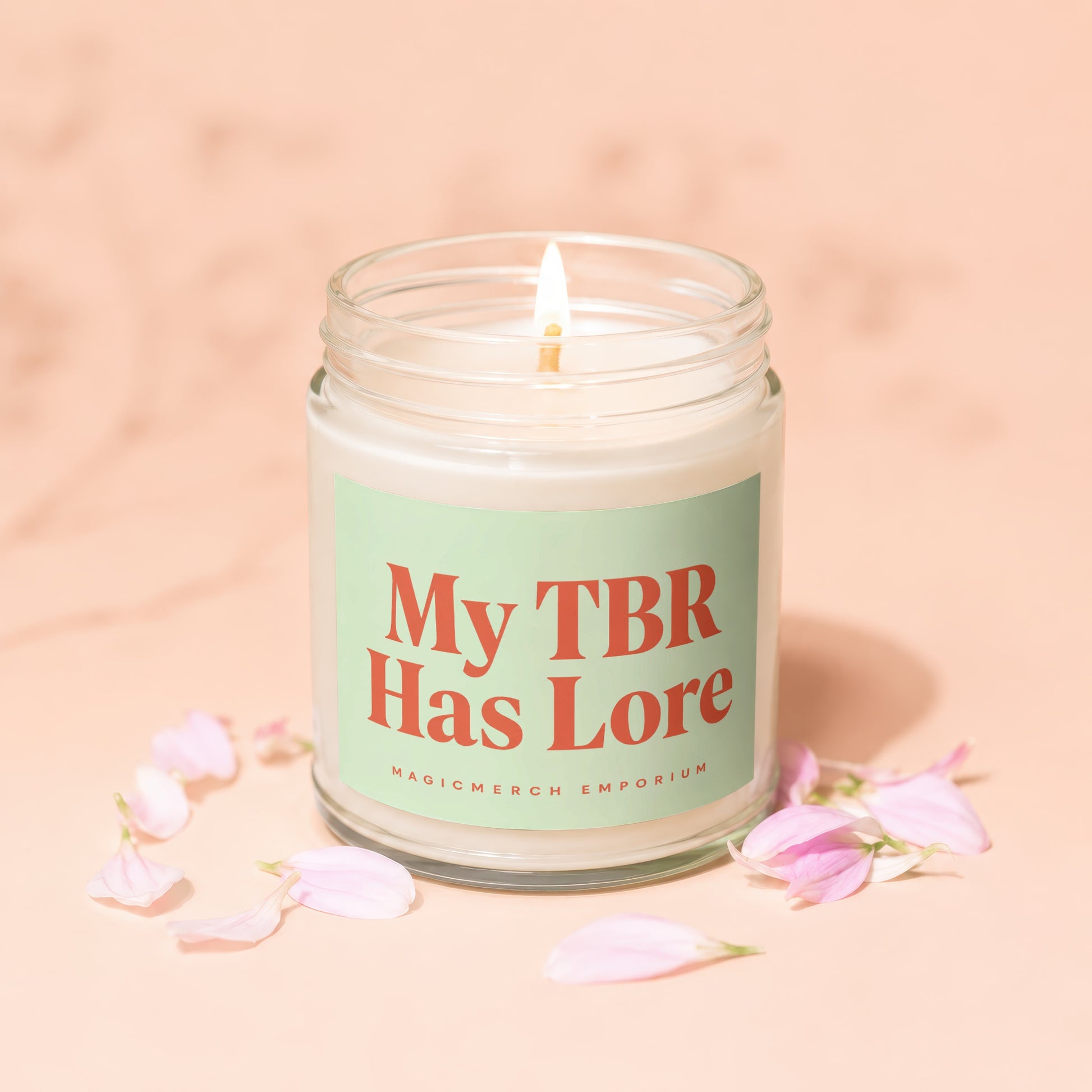 Glass candle with lit wick and "My TBR Has Lore" text.