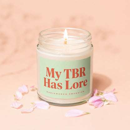 Glass candle with lit wick and "My TBR Has Lore" text.
