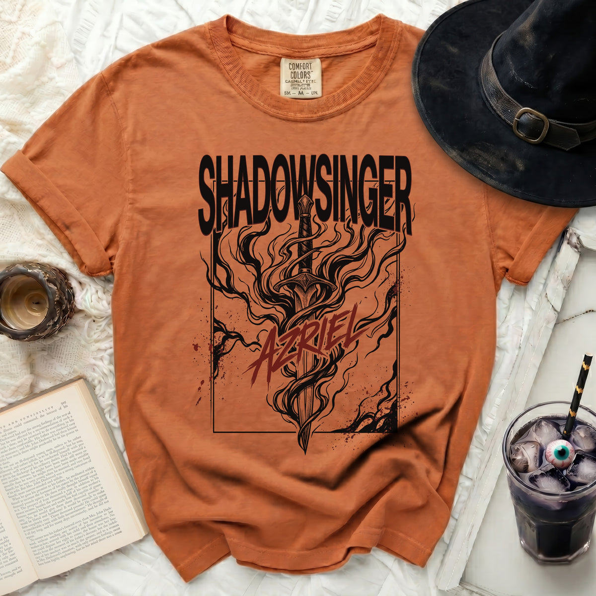 Orange t-shirt with "SHADOWSINGER" and a sword with flames design.