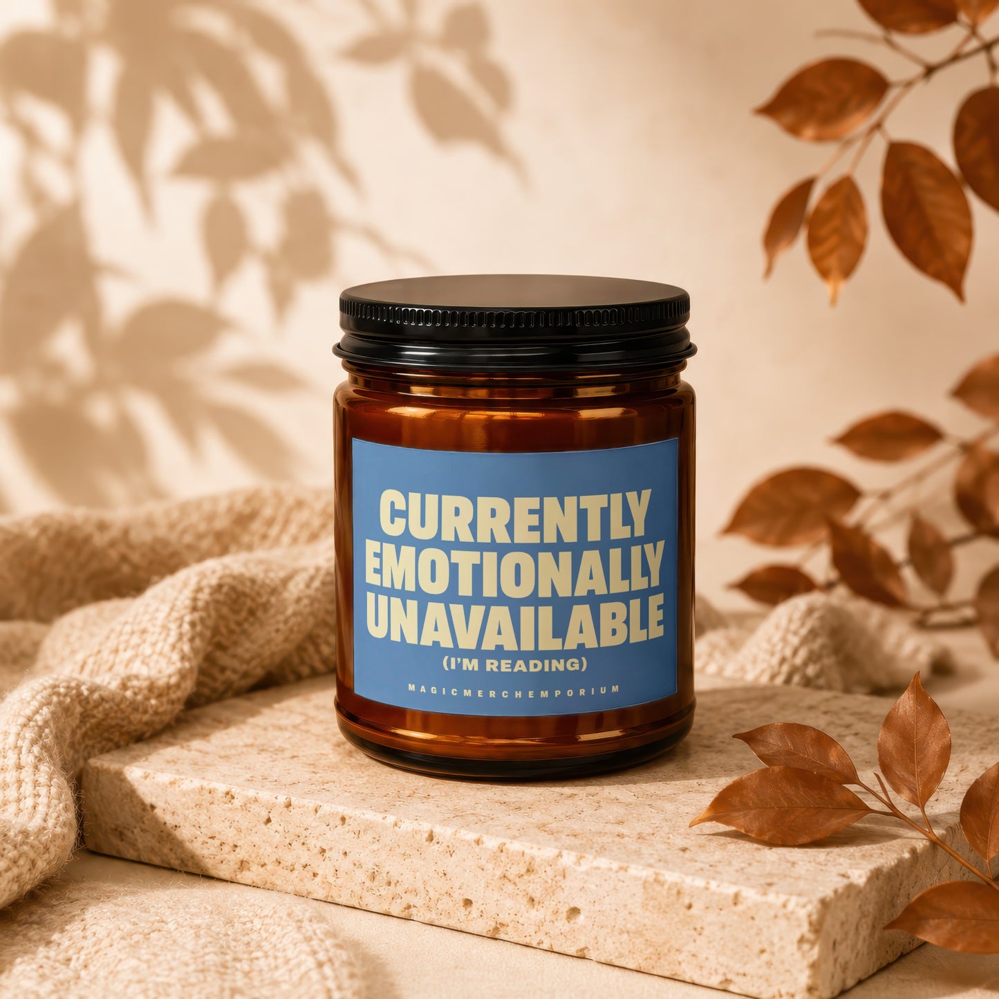 Brown jar candle with blue label reading "Currently Emotionally Unavailable (I'm Reading)".