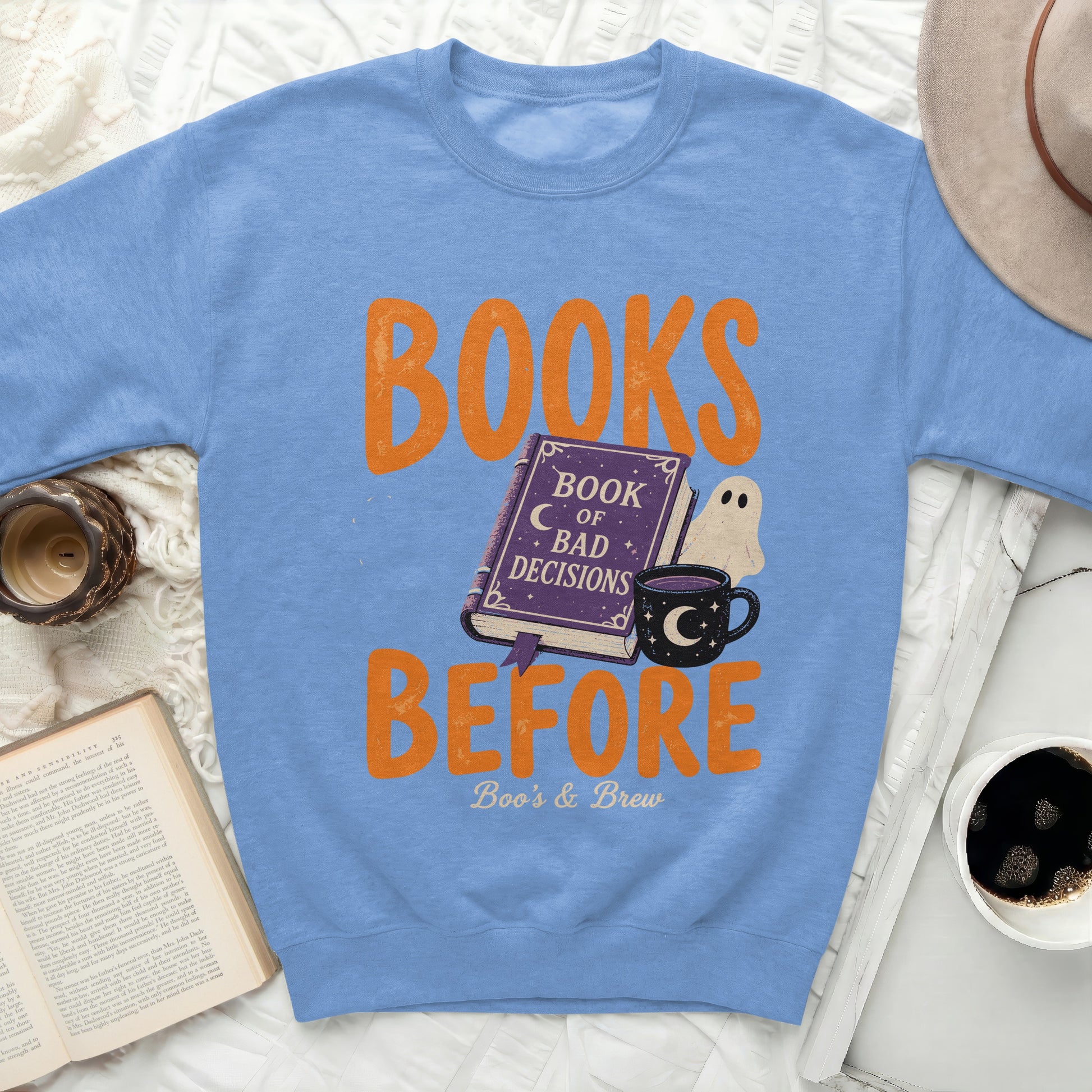 Light blue sweatshirt with "Books Before Bad Decisions" graphic.