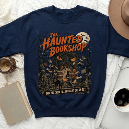 Navy sweatshirt with "The Haunted Bookshop" graphic featuring a spooky house, ghost, cat, and flying books.