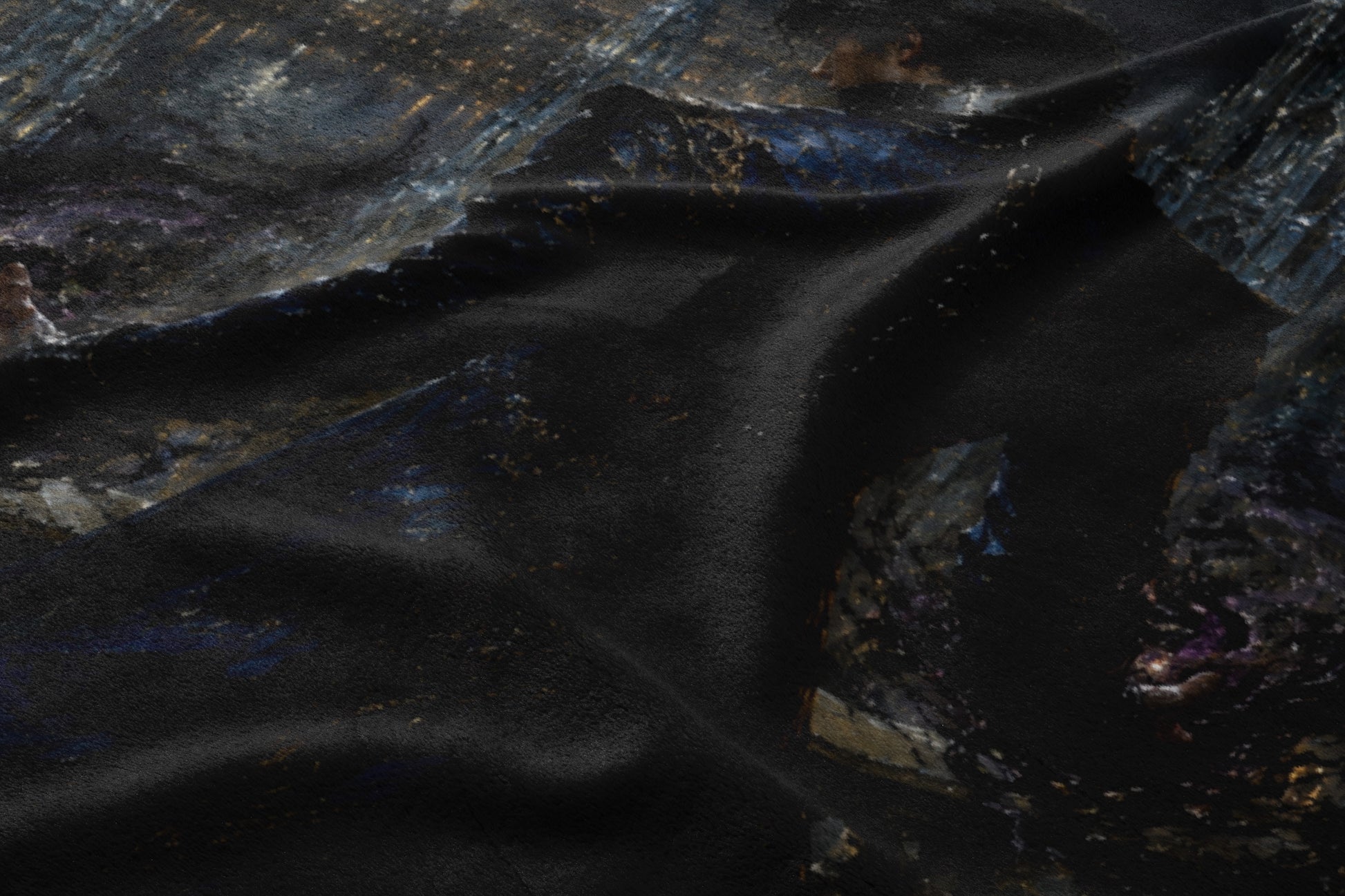 Dark fabric with an abstract, textured pattern of dark blues, grays, and gold.