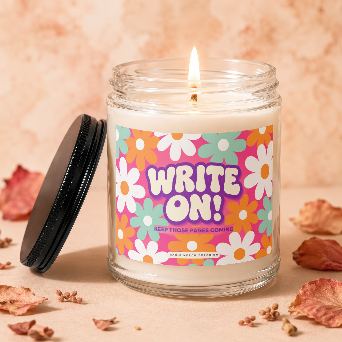 Jar candle with "WRITE ON! KEEP THOSE PAGES COMING" text and floral pattern.