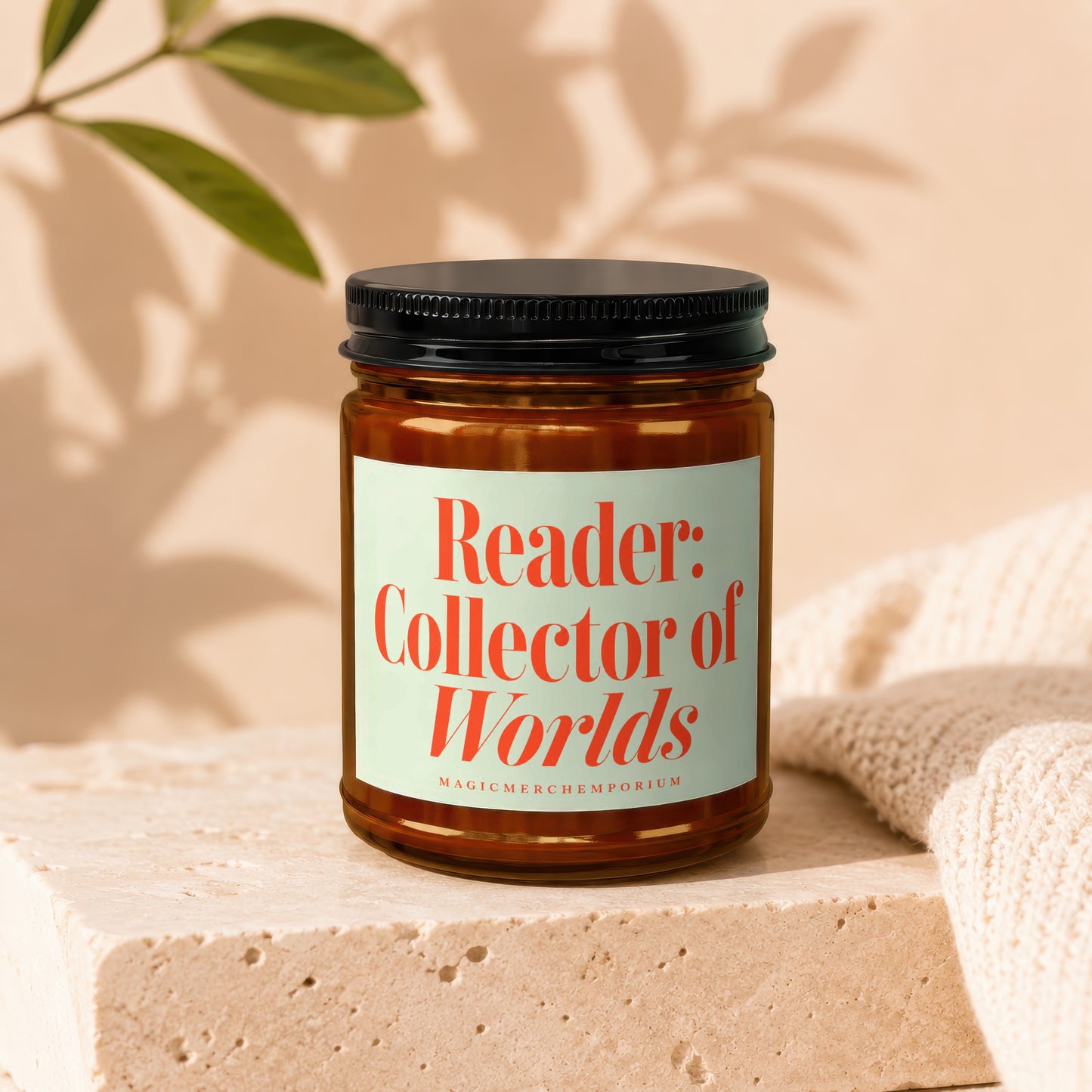 Candle with text "Reader: Collector of Worlds" and "MAGICMERCHEMPORIUM".