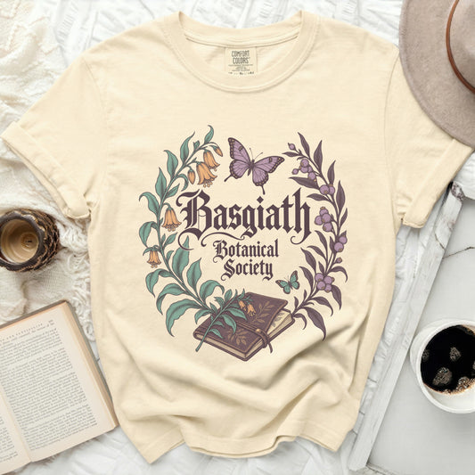 Light yellow t-shirt with "Basgiath Botanical Society" text and floral design.
