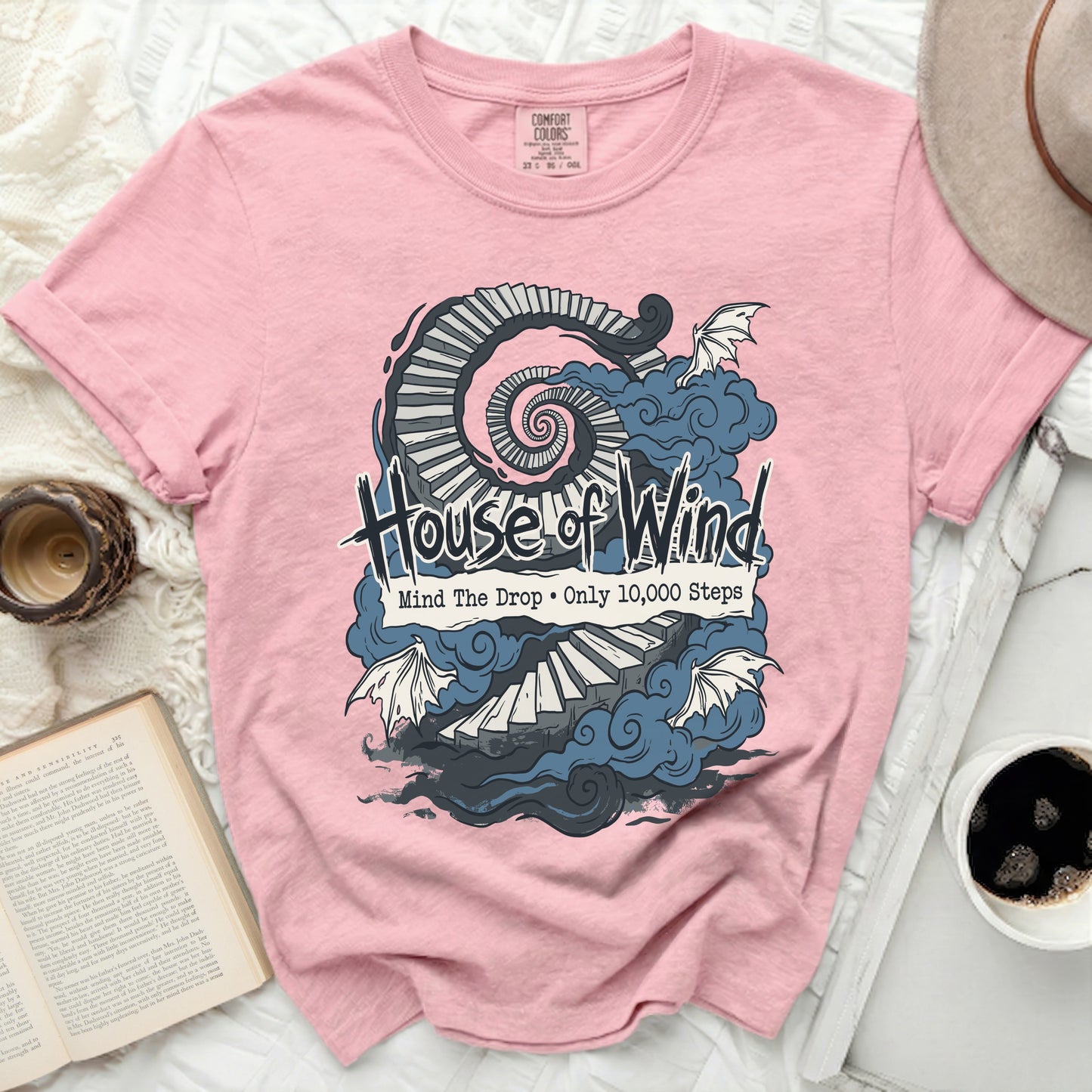 Pink Comfort Colors t-shirt with "House of Wind" and spiral staircase graphic.