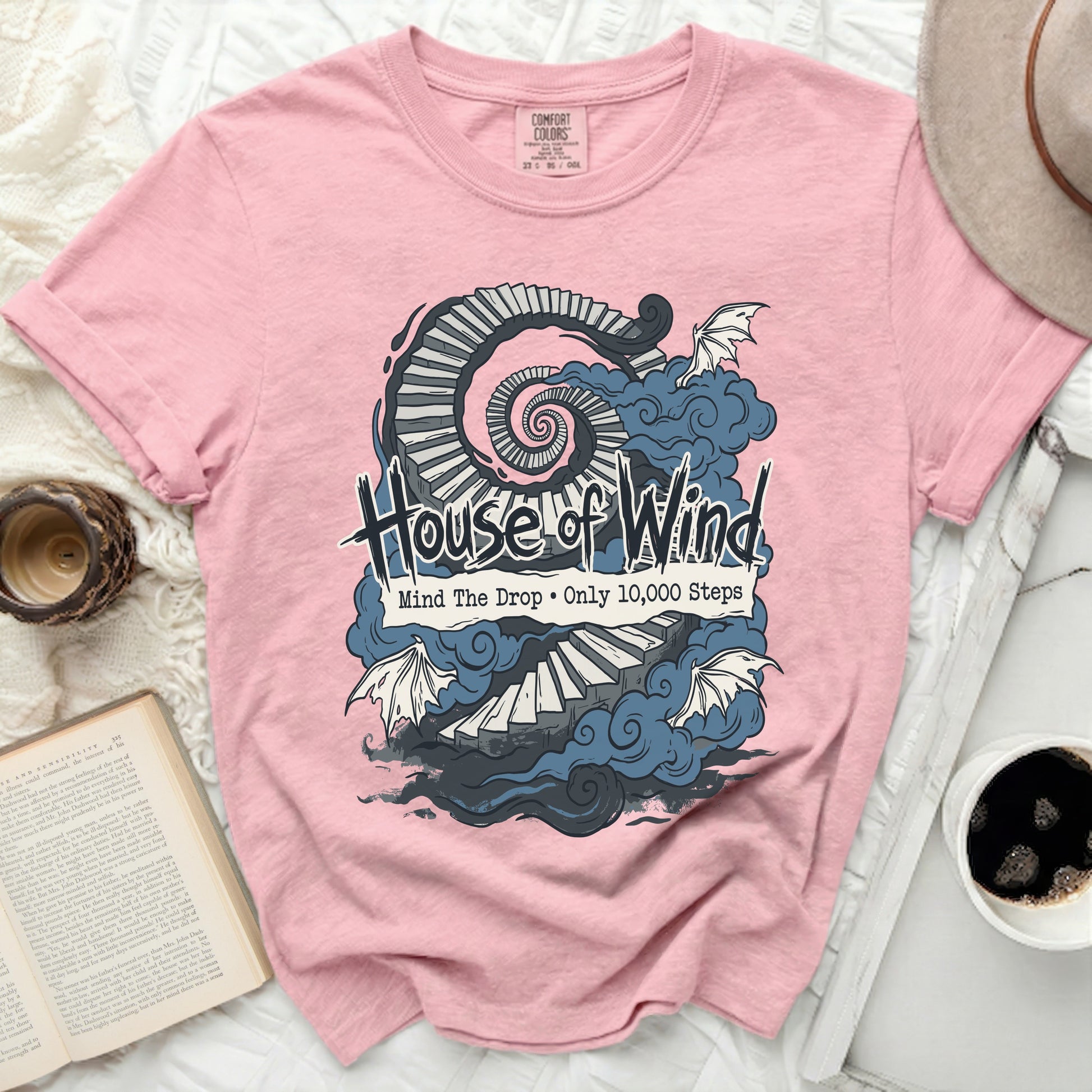 Pink Comfort Colors t-shirt with "House of Wind" and spiral staircase graphic.