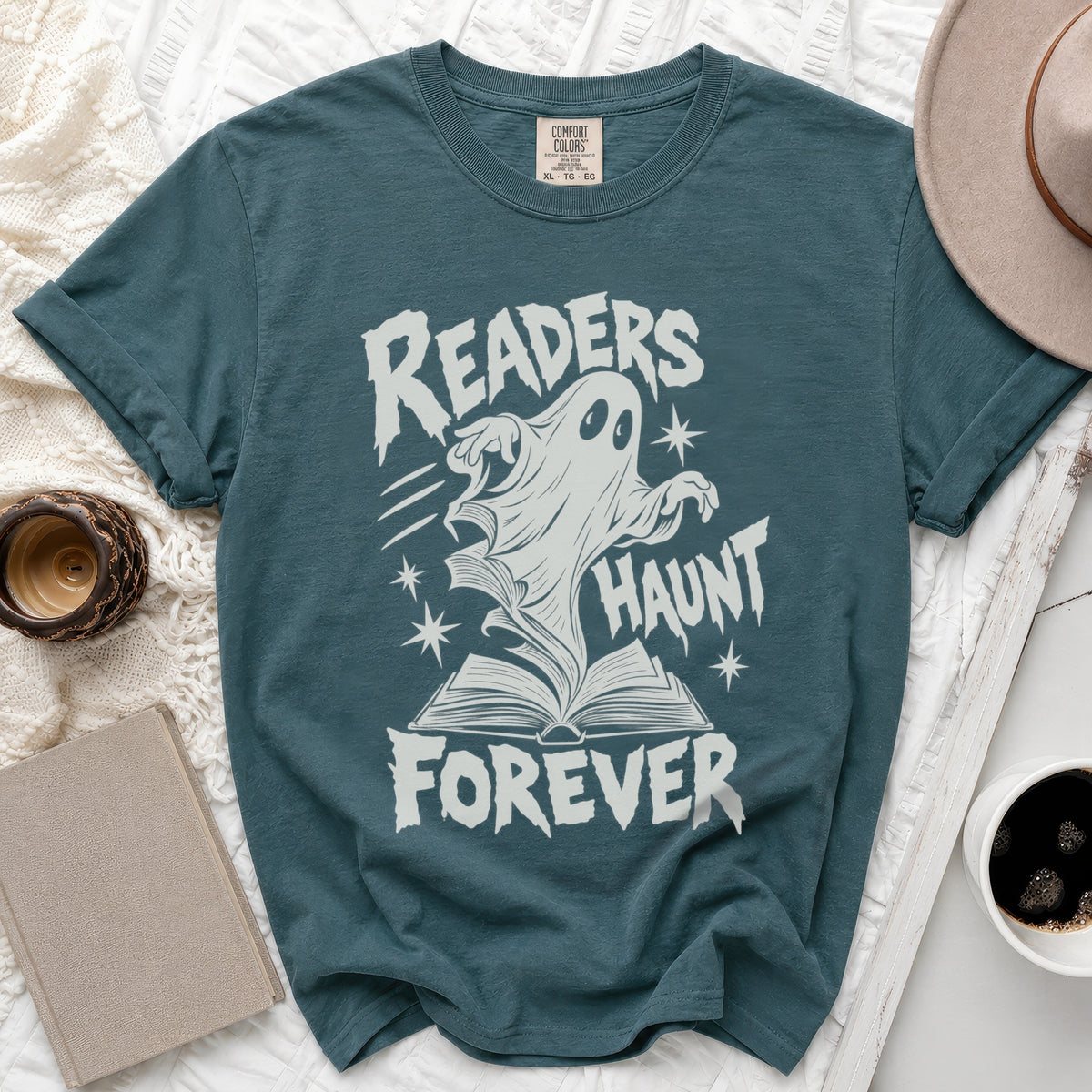 Teal t-shirt with ghost and open book graphic reading "Readers Haunt Forever".