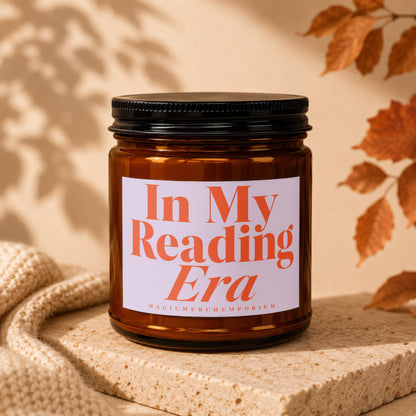 Amber jar candle with white label reading "In My Reading Era"