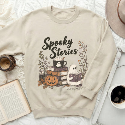 Beige sweatshirt with "Spooky Stories" text, ghost, pumpkin, and books graphic.