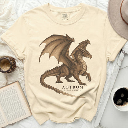 Cream t-shirt with a brown dragon graphic and text "AOTROM RIDOC GAMLYN".