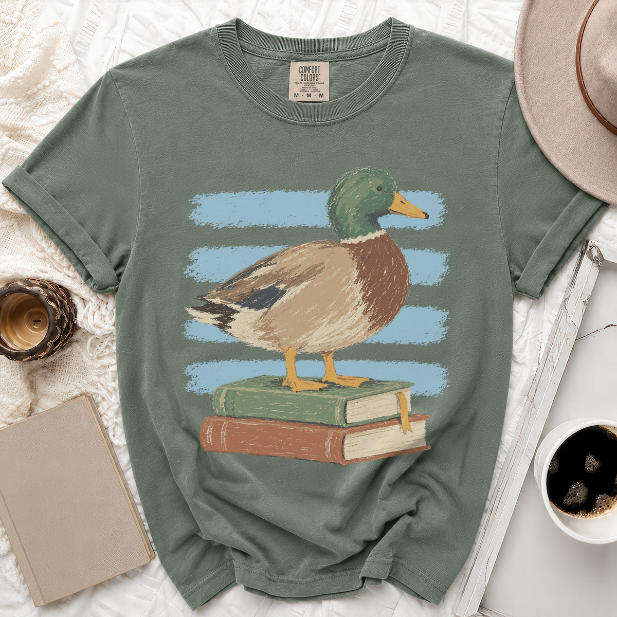 Mallard duck standing on stacked books with blue stripes background on t-shirt.