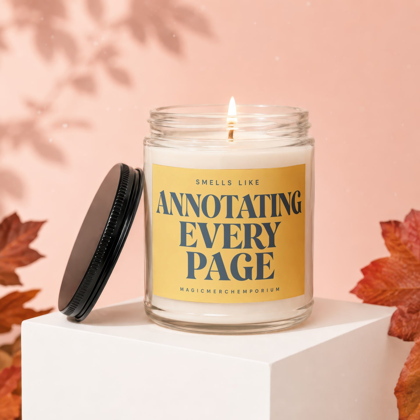 Glass candle with yellow label reading "Smells like Annotating Every Page"