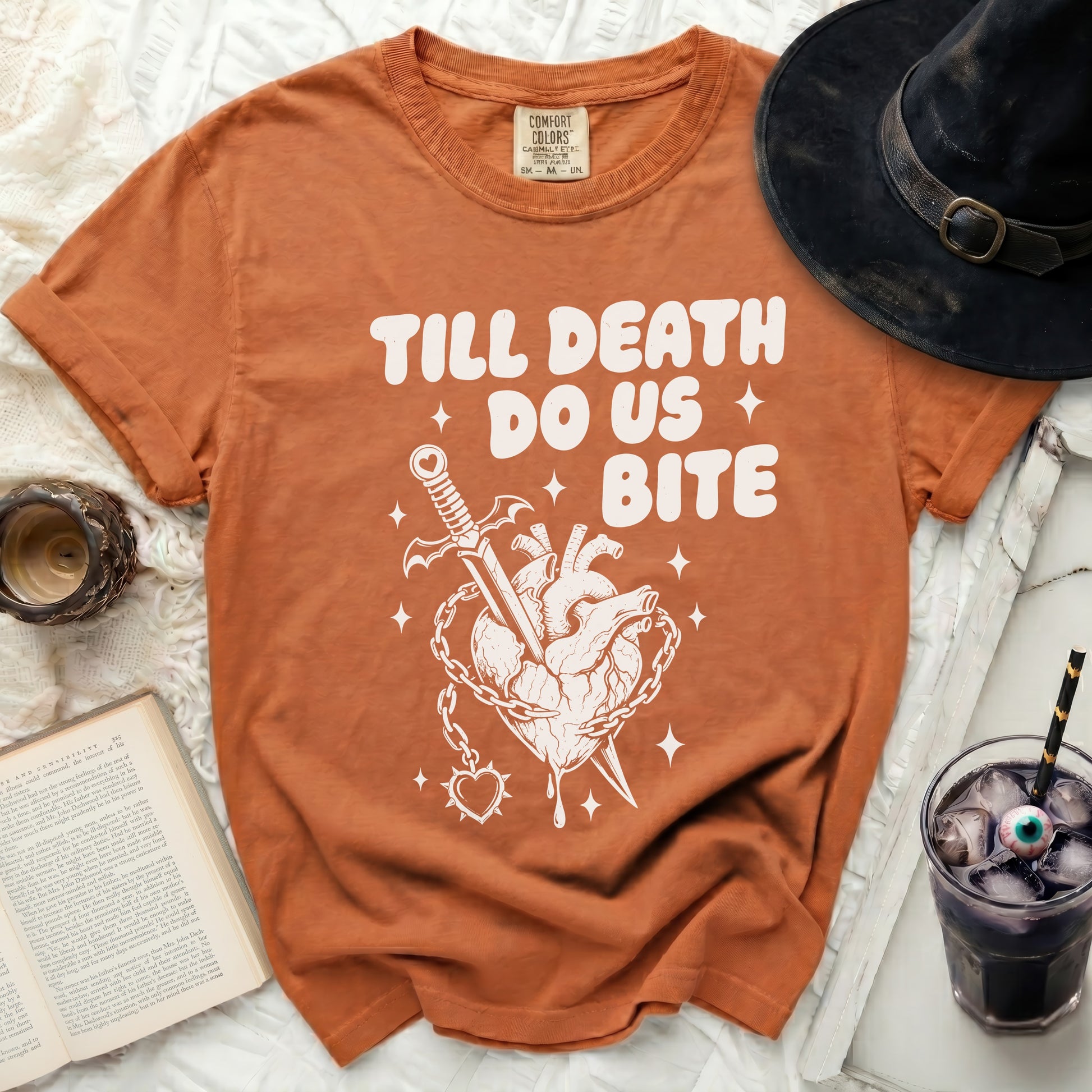 Orange t-shirt with "Till Death Do Us Bite" graphic of a heart with dagger and chains.