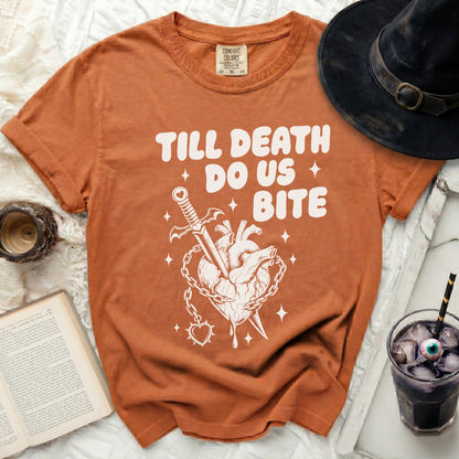 Orange t-shirt with "Till Death Do Us Bite" graphic of a heart with dagger and chains.