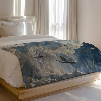 Dragons fly through a cloudy, starry night sky on a blanket on a bed.