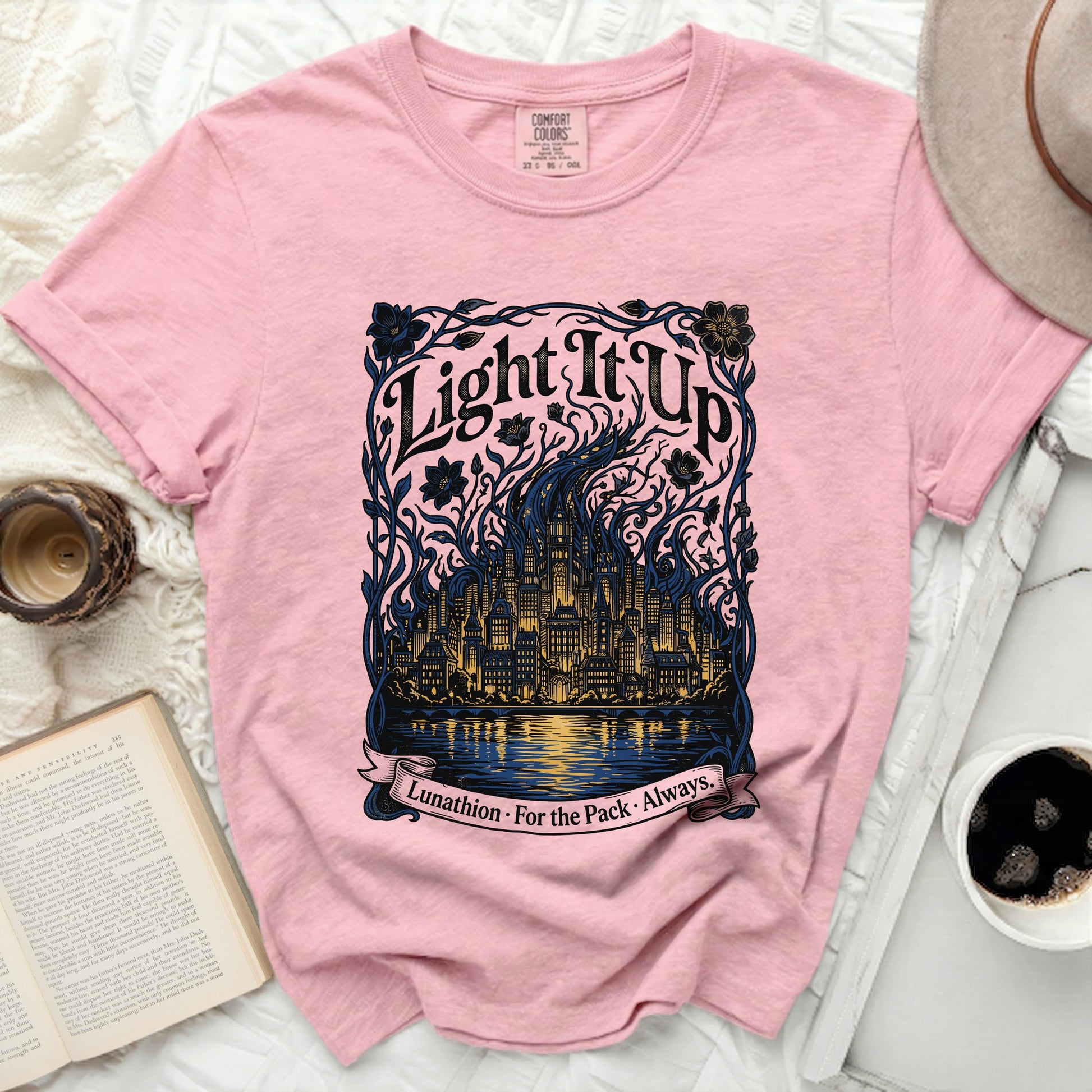 Pink t-shirt with "Light It Up Lunathion. For the Pack. Always." text and cityscape graphic.