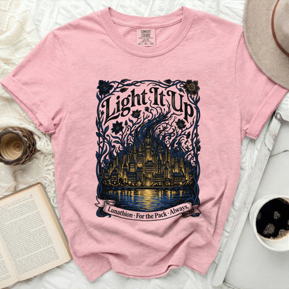 Pink t-shirt with "Light It Up Lunathion. For the Pack. Always." text and cityscape graphic.