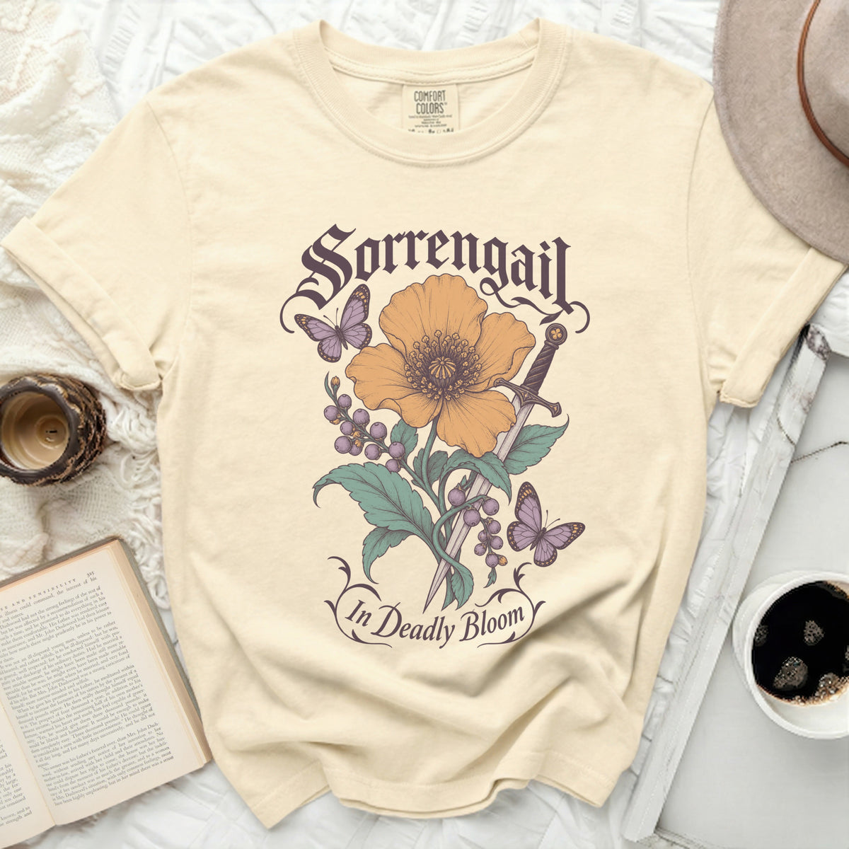 Cream t-shirt with "Sorrengail In Deadly Bloom" text and floral sword design.