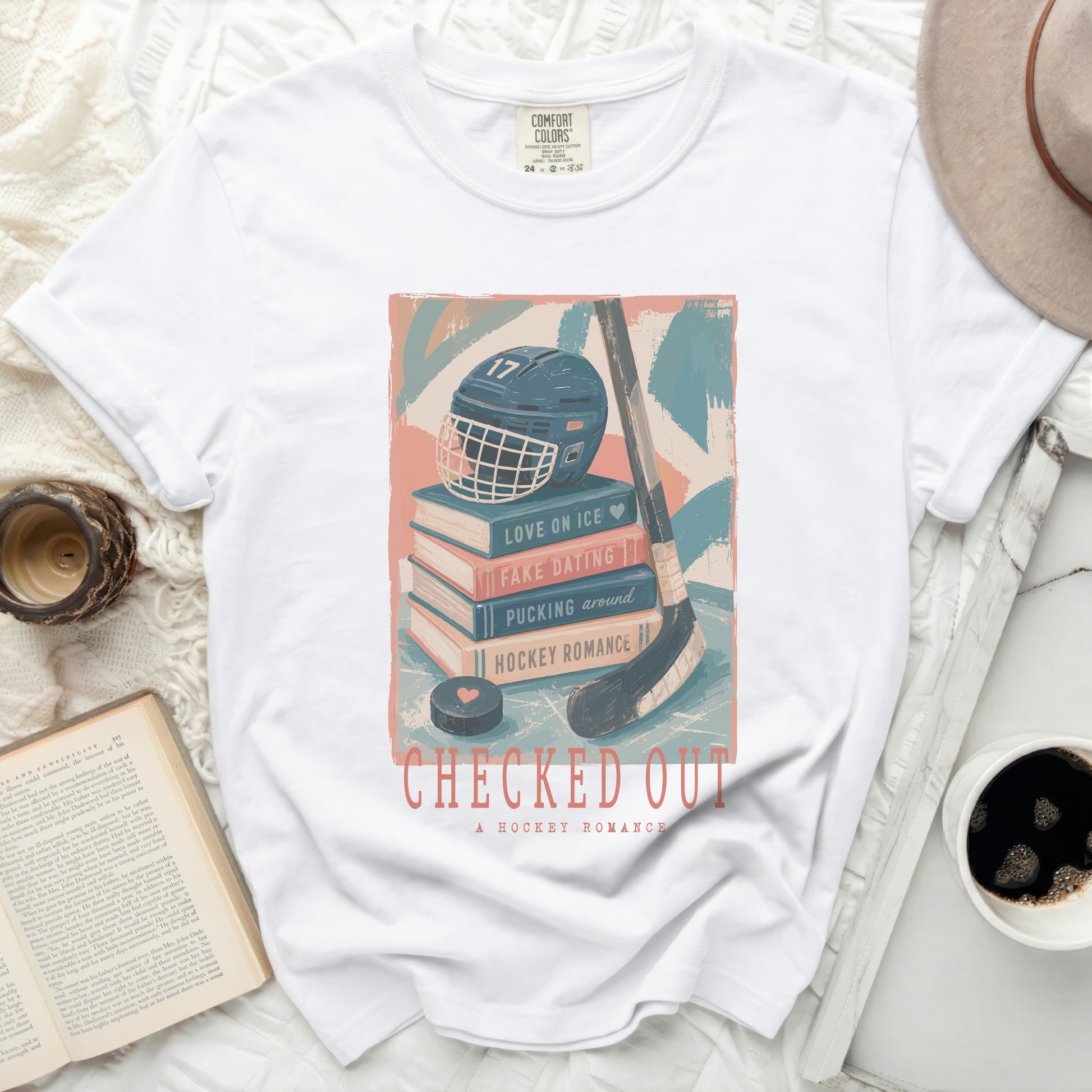 White t-shirt with "Checked Out: A Hockey Romance" and hockey graphics.