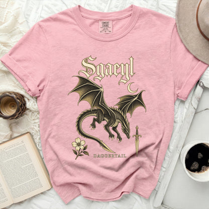 Pink t-shirt with a black dragon, "Sgaeyl," dagger, and flower graphic.