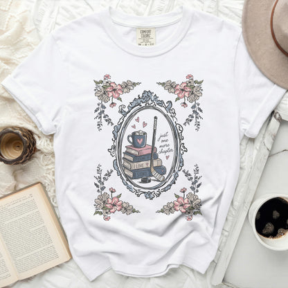 White Comfort Colors t-shirt with floral frame and "just one more chapter" book stack.