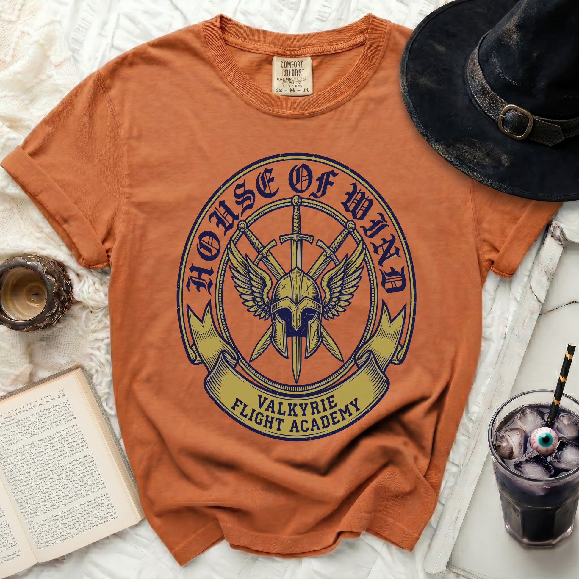 Orange t-shirt with "House of Wind Valkyrie Flight Academy" crest design.